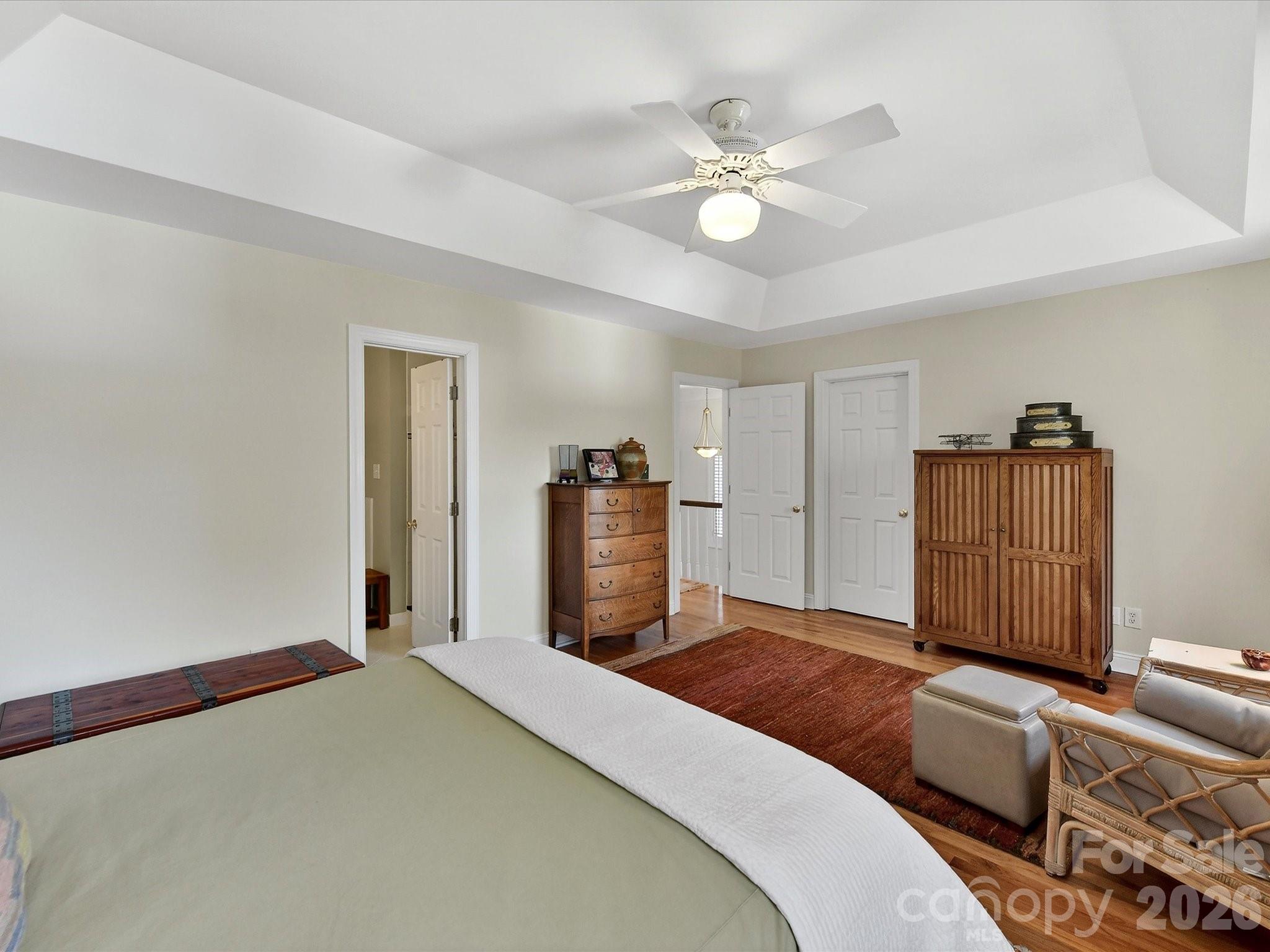 207 Hobbs Street Davidson, NC 28036 - Photo 19 of 40 a bedroom with a large bed and chandelier