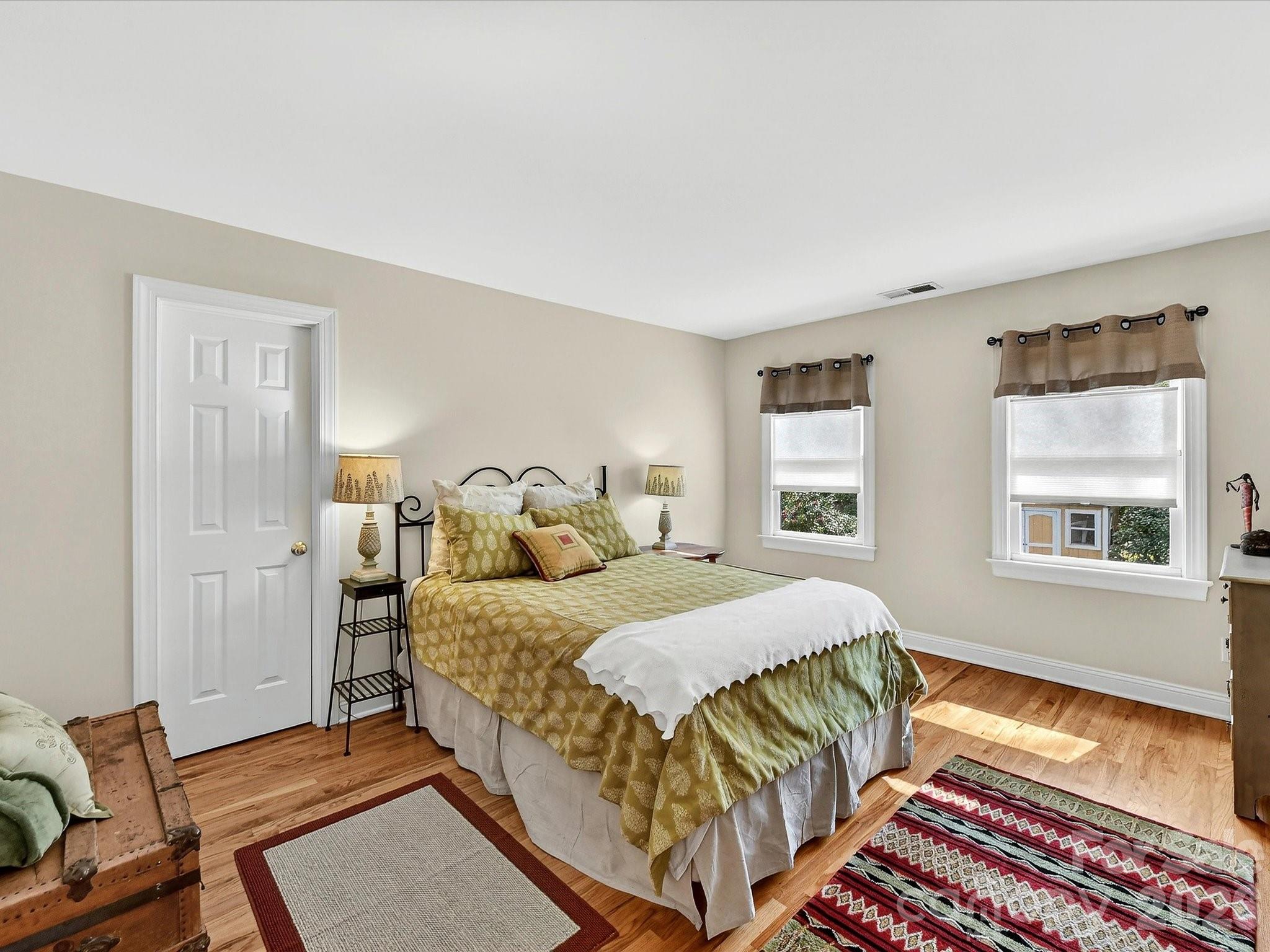 207 Hobbs Street Davidson, NC 28036 - Photo 26 of 40 a bedroom with a bed and wooden floor