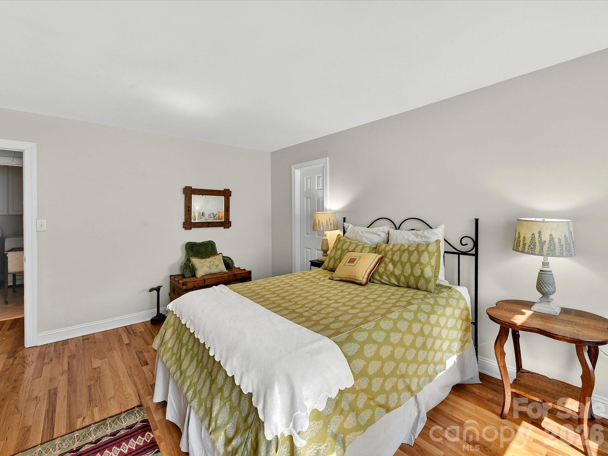207 Hobbs Street Davidson, NC 28036 - Photo 27 of 40 a bedroom with a bed and wooden floor