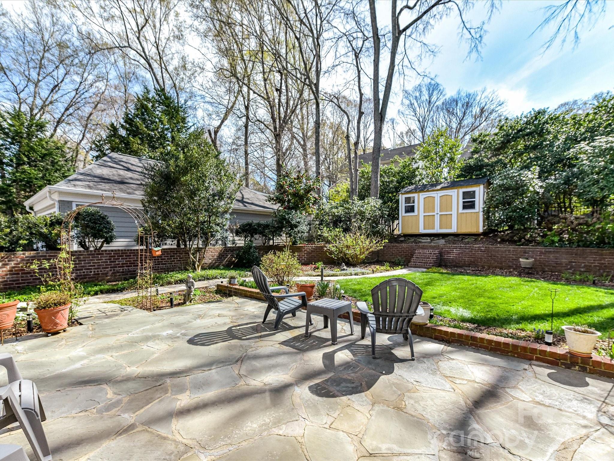 207 Hobbs Street Davidson, NC 28036 - Photo 31 of 40 a view of backyard with outdoor seating and trees