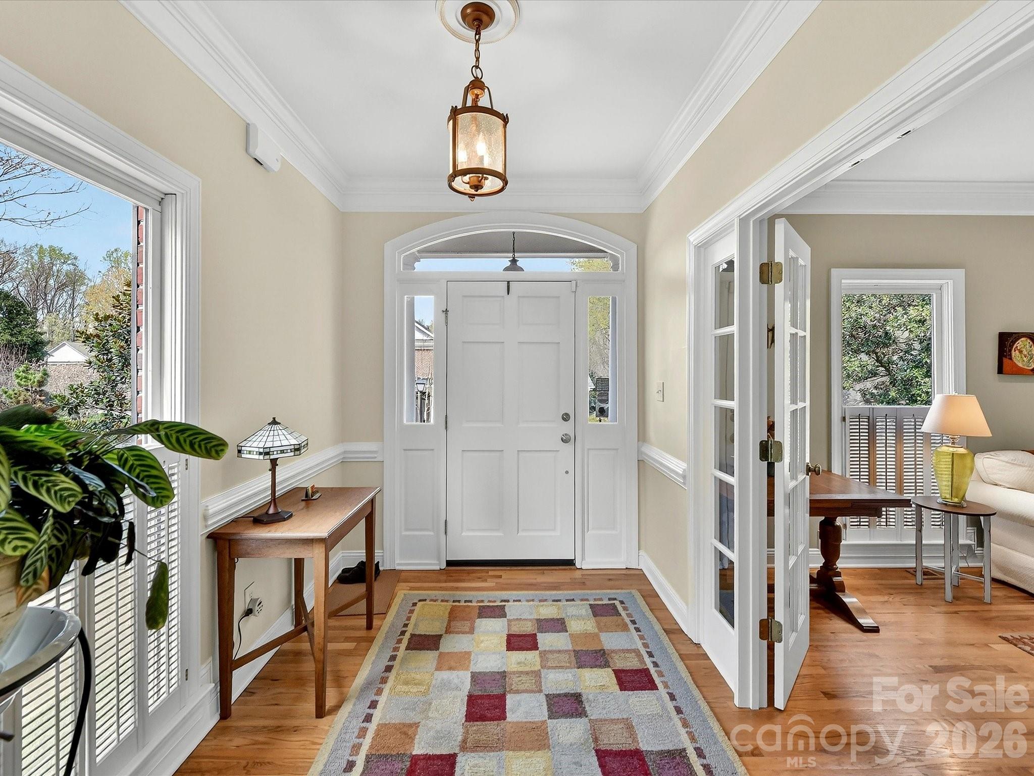 207 Hobbs Street Davidson, NC 28036 - Photo 5 of 40 a hallway with furniture and wooden floor