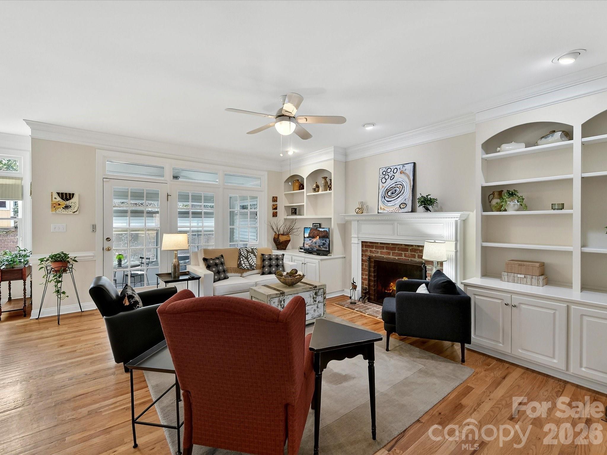 207 Hobbs Street Davidson, NC 28036 - Photo 9 of 40 a living room with furniture a fireplace and a table