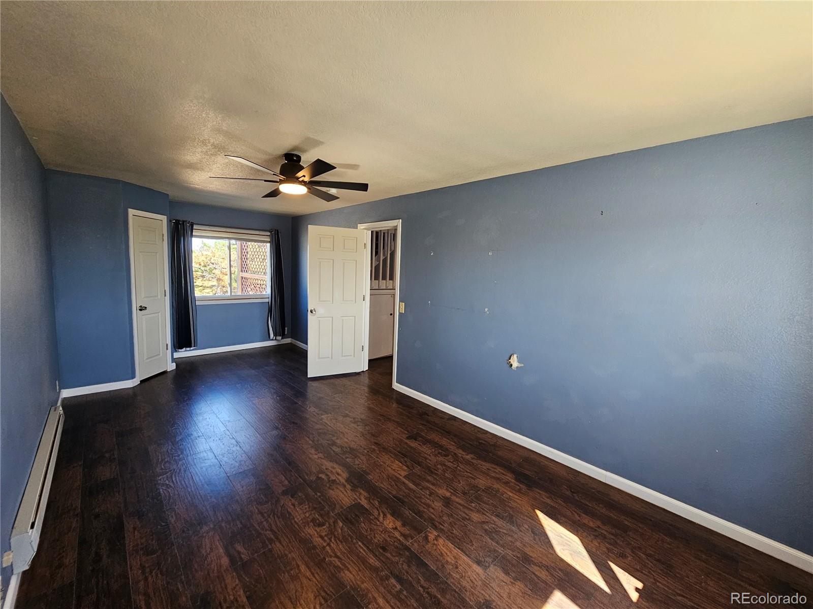 16985 Sage Crest Road Peyton, CO 80831 - Photo 10 of 25 a view of an empty room with window and wooden floor