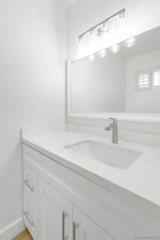 a view of kitchen with white cabinets