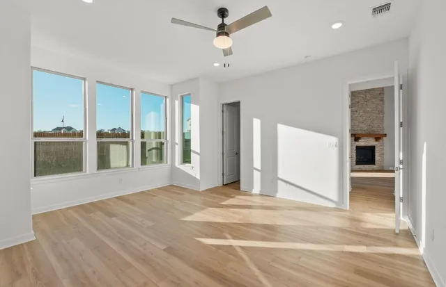 a kitchen with a sink a counter top space stainless steel appliances and a ceiling fan