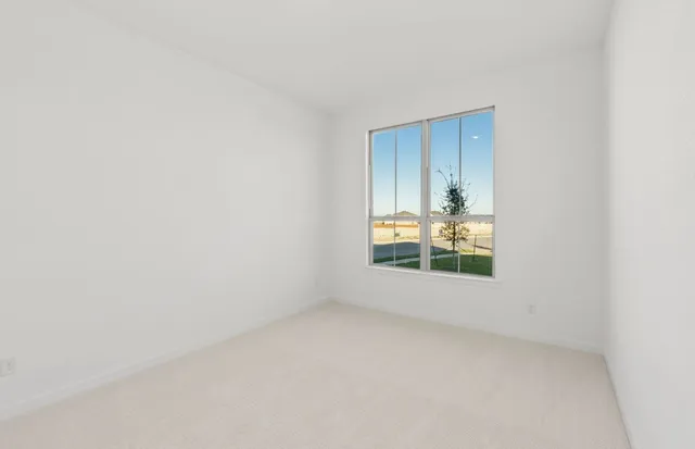 a view of a room with wooden floor and white walls