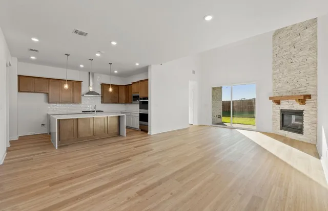 a kitchen with a sink a counter top space stainless steel appliances and cabinets