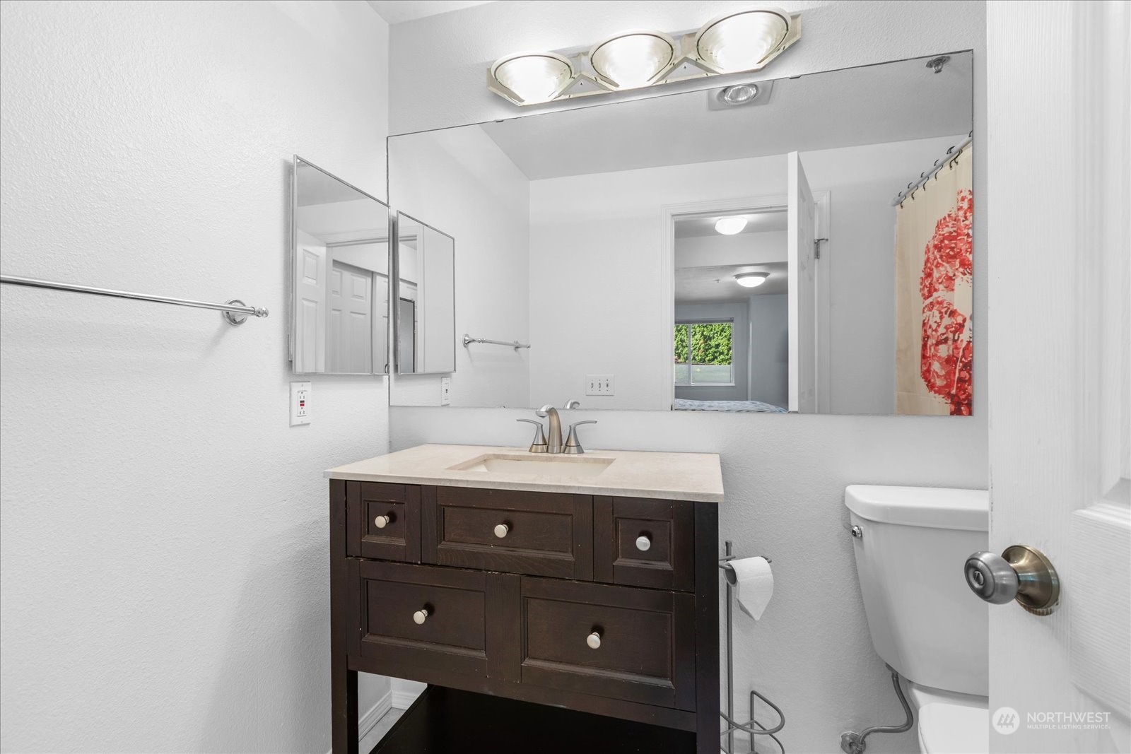 19316 Bothell Way Northeast, Unit C203 Bothell, WA 98011 - Photo 15 of 27 a bathroom with a toilet a sink and mirror