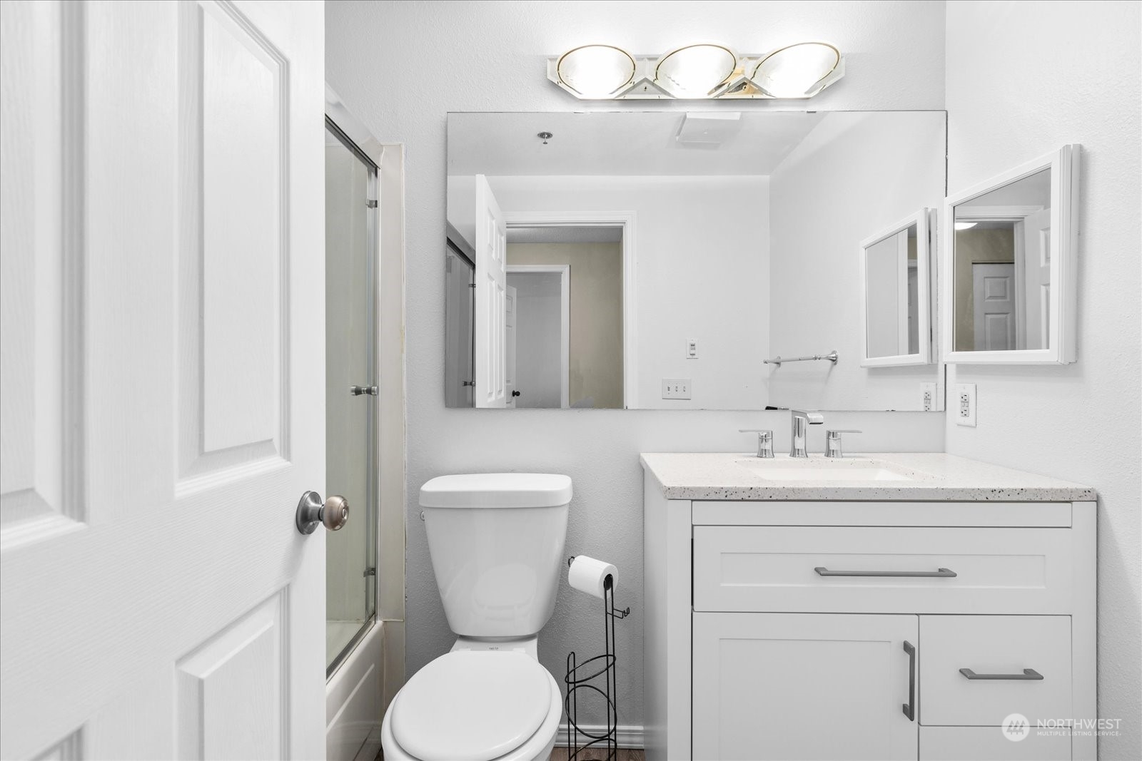 19316 Bothell Way Northeast, Unit C203 Bothell, WA 98011 - Photo 19 of 27 a bathroom with a toilet a sink and mirror