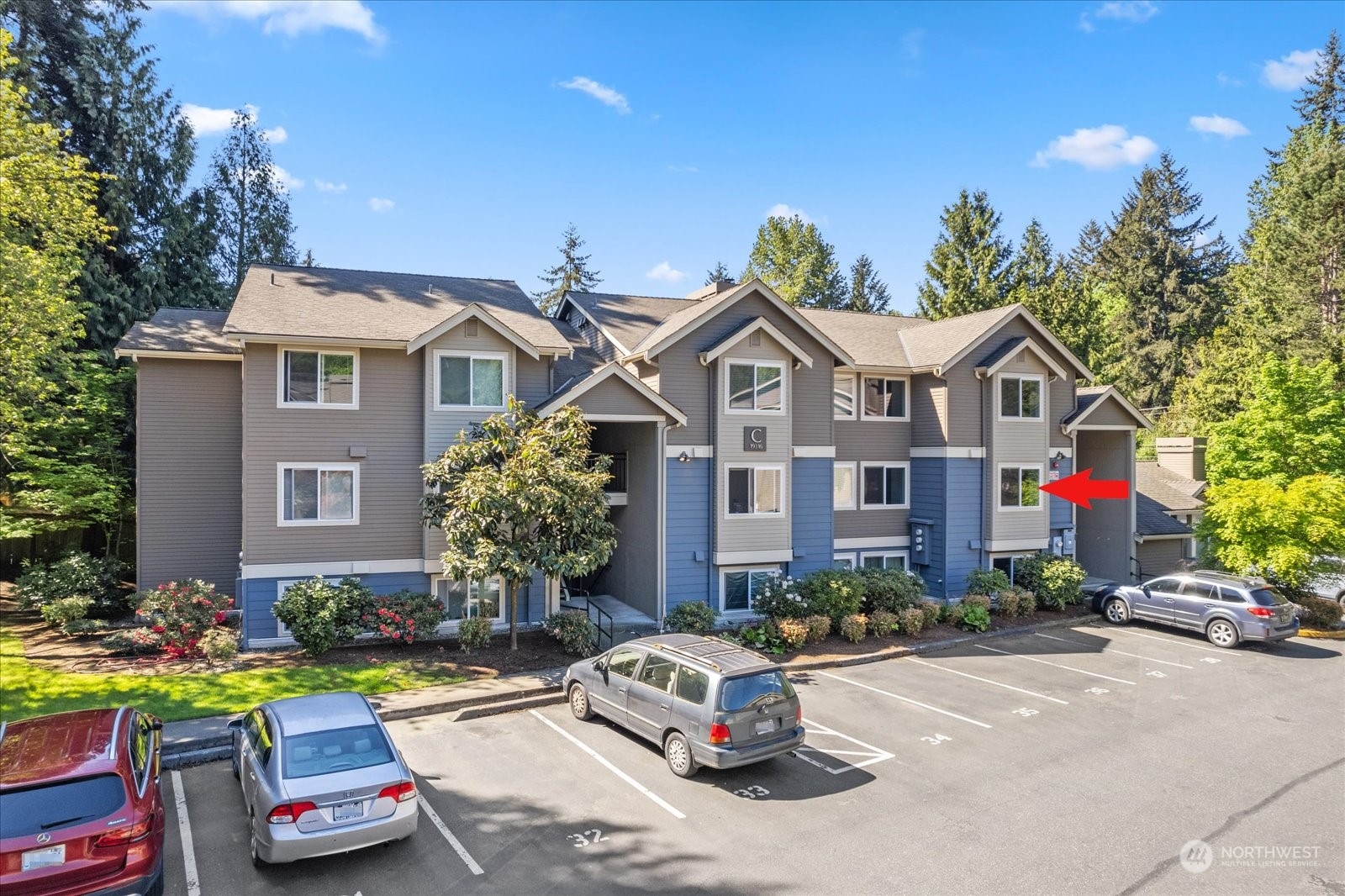 19316 Bothell Way Northeast, Unit C203 Bothell, WA 98011 - Photo 24 of 27 a front view of a house with a garden and plants