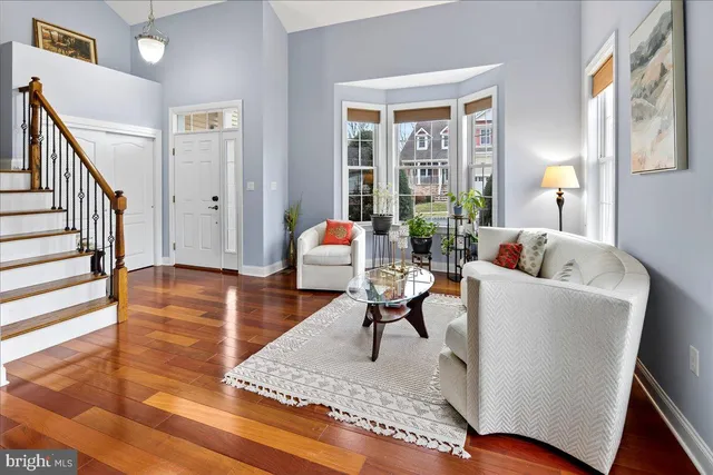 a living room with furniture and a table with wooden floor