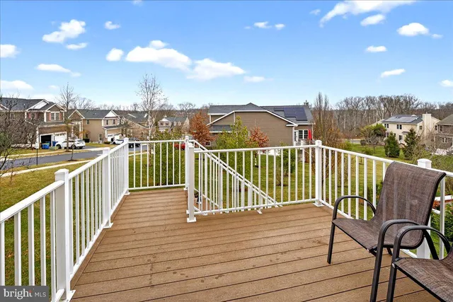a view of a balcony with wooden chairs