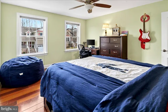 a bed sitting in a bedroom next to a window