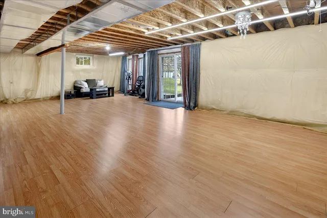 a view of a room with wooden floor