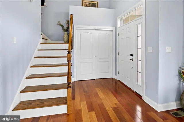 a view of entryway with wooden floor and stairs