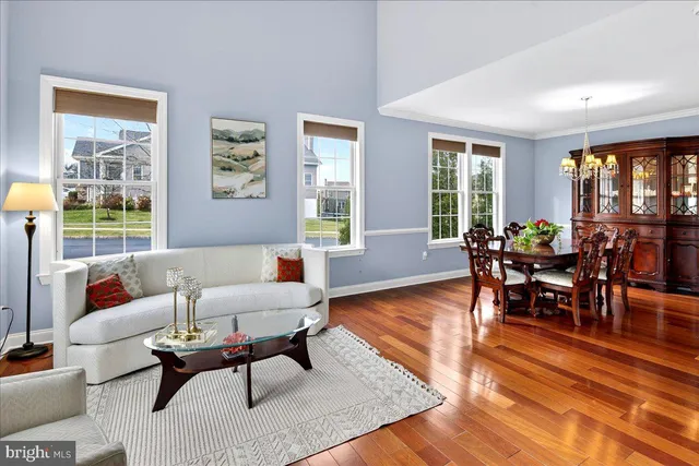 a living room with furniture and large windows