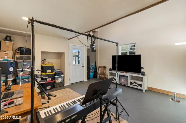 a bedroom with furniture and a flat screen tv