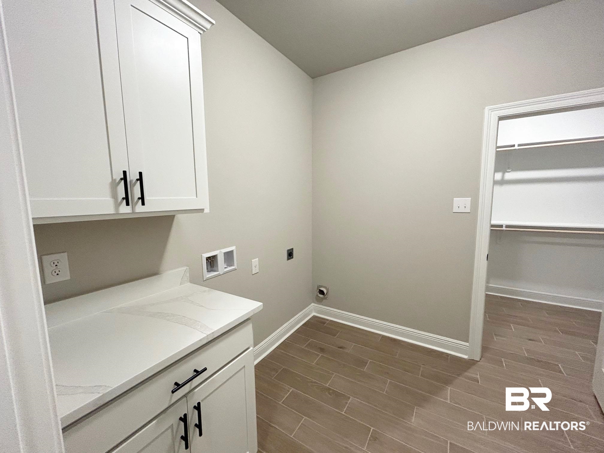 877 Sumter Loop Foley, AL 36535 - Photo 13 of 18 Laundry area with baseboards, wood finish floors, hookup for a washing machine, cabinet space, and electric dryer hookup