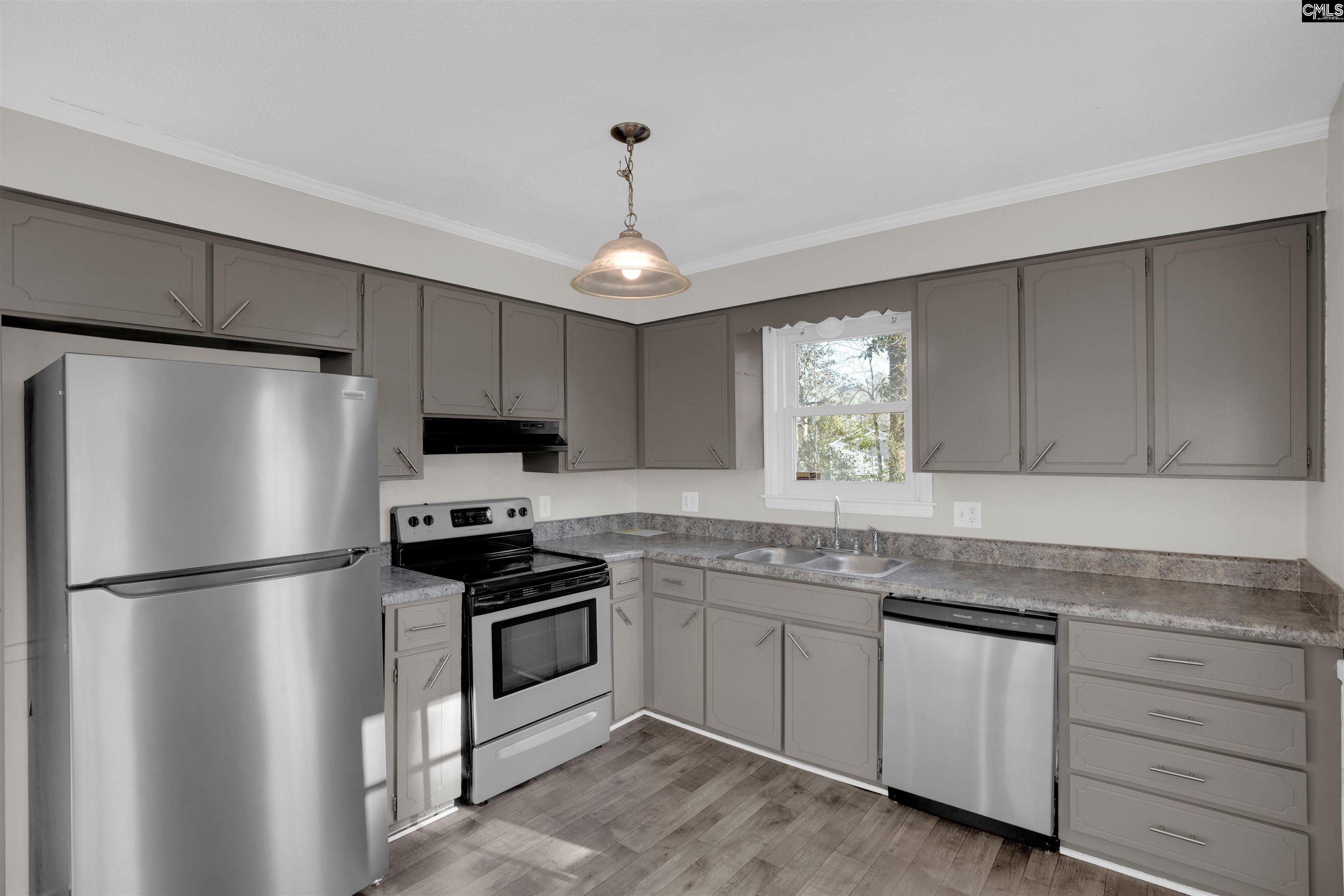 2620 Pleasant Ridge Drive Columbia, SC 29209 - Photo 10 of 37 a kitchen with white cabinets stainless steel appliances and a window