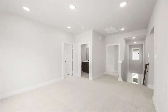 an empty room with closet and a bathroom