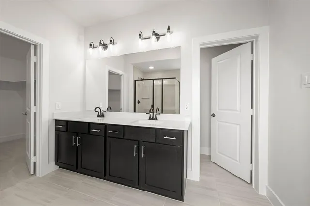 a bathroom with a double vanity sink and mirror