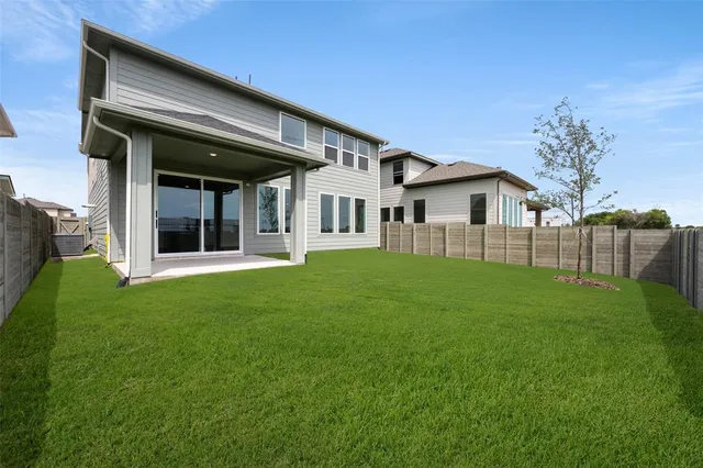 a view of a house with a backyard