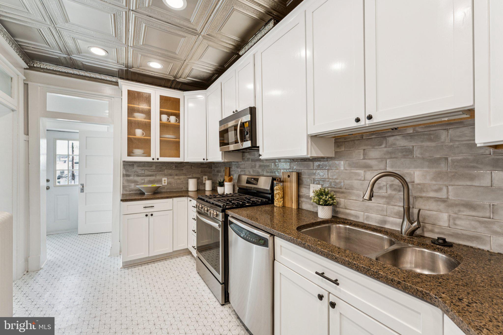 1412 Decatur Street Northwest Washington, DC 20011 - Photo 11 of 36 a kitchen with granite countertop a sink stainless steel appliances and cabinets