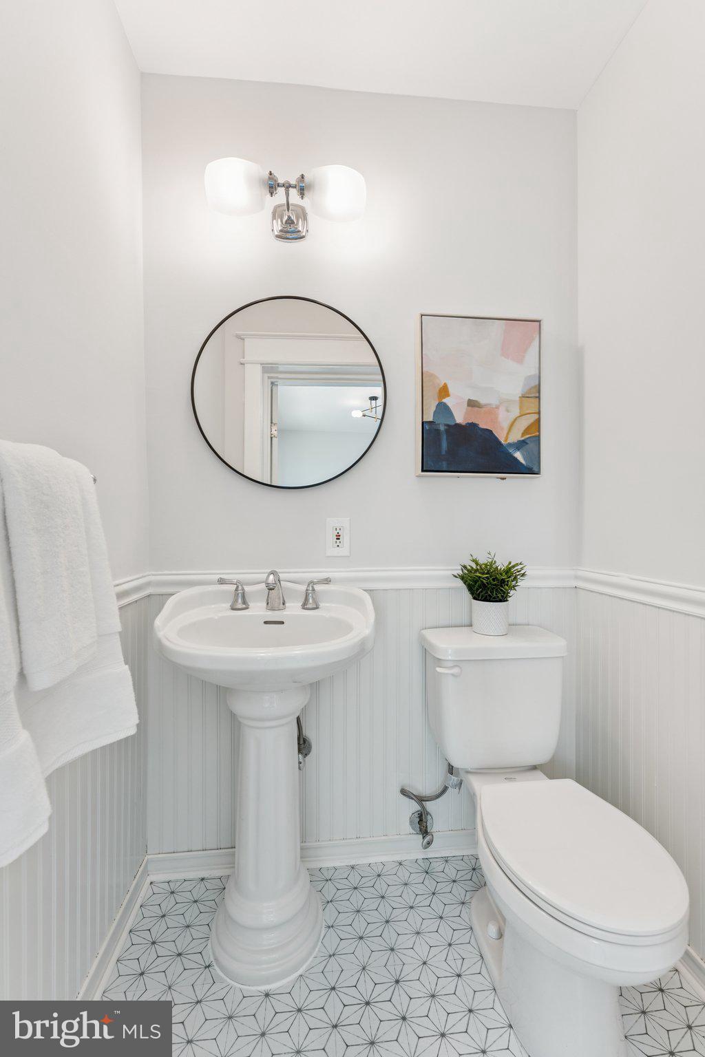 1412 Decatur Street Northwest Washington, DC 20011 - Photo 14 of 36 a bathroom with a toilet a sink and mirror