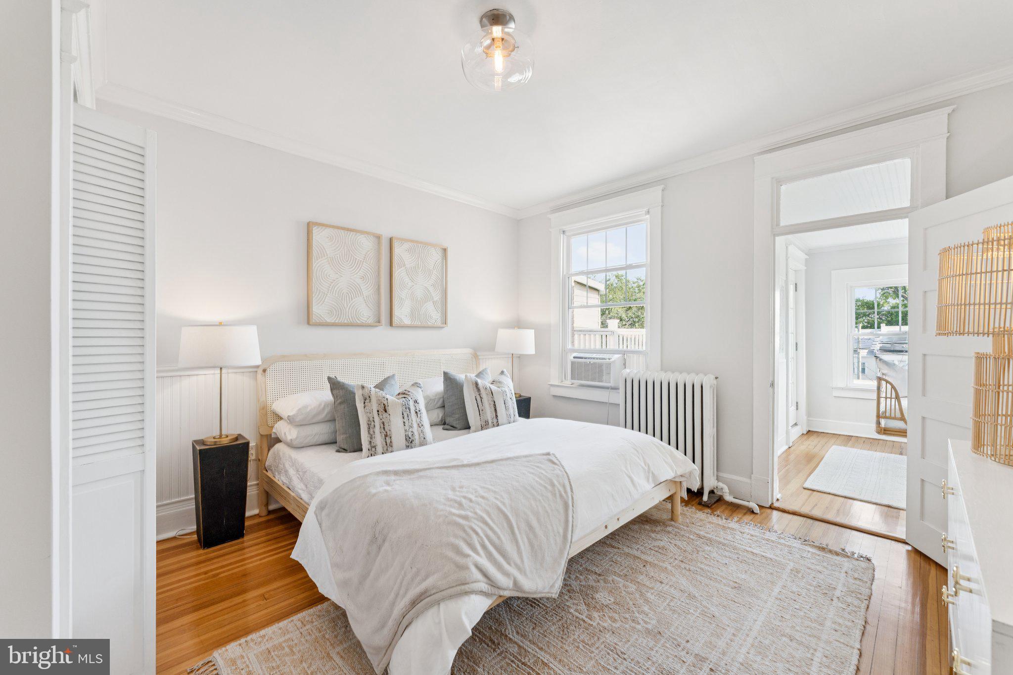 1412 Decatur Street Northwest Washington, DC 20011 - Photo 15 of 36 a bedroom with a bed and a chandelier