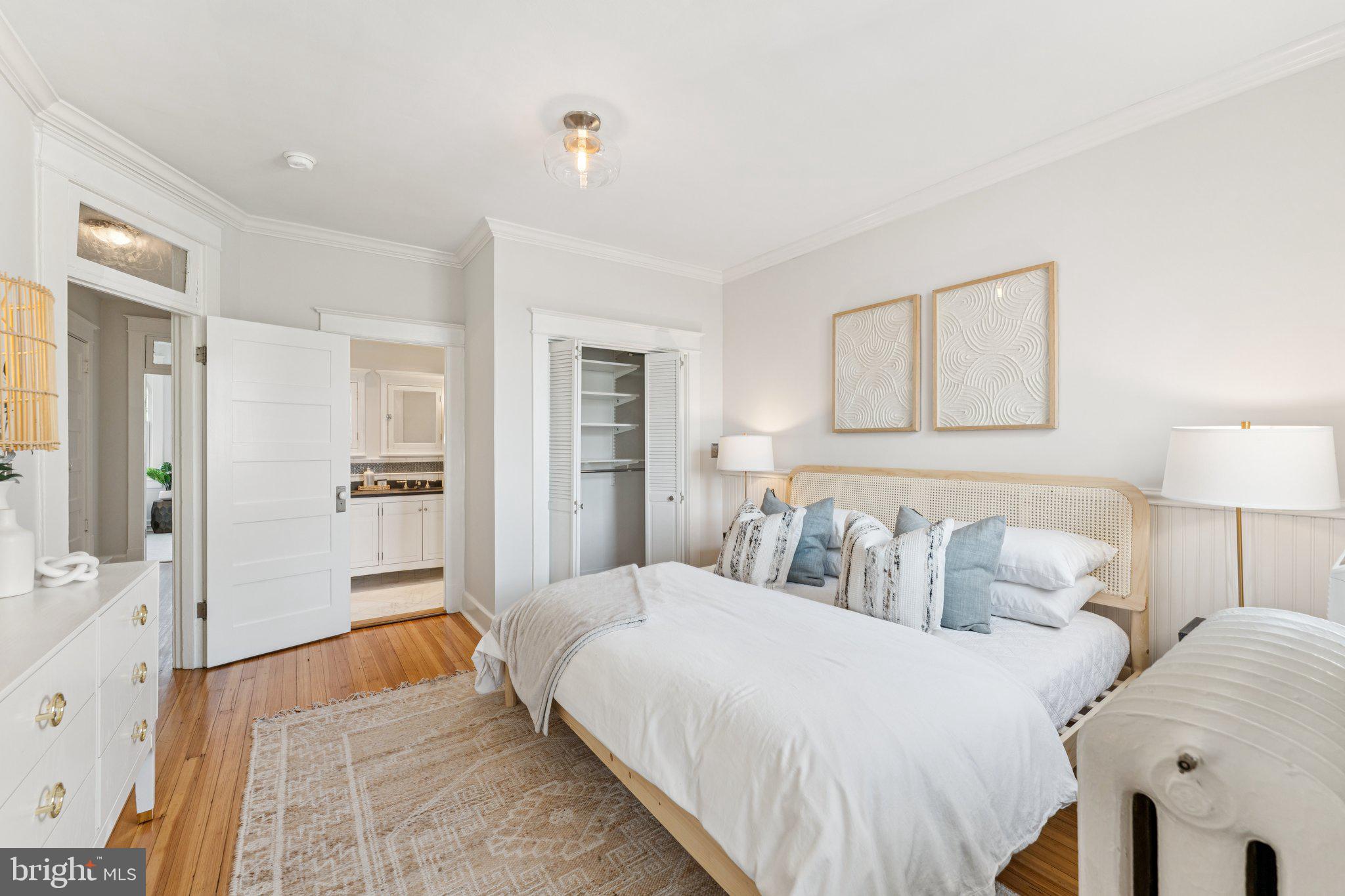 1412 Decatur Street Northwest Washington, DC 20011 - Photo 16 of 36 a spacious bedroom with a bed and a couch