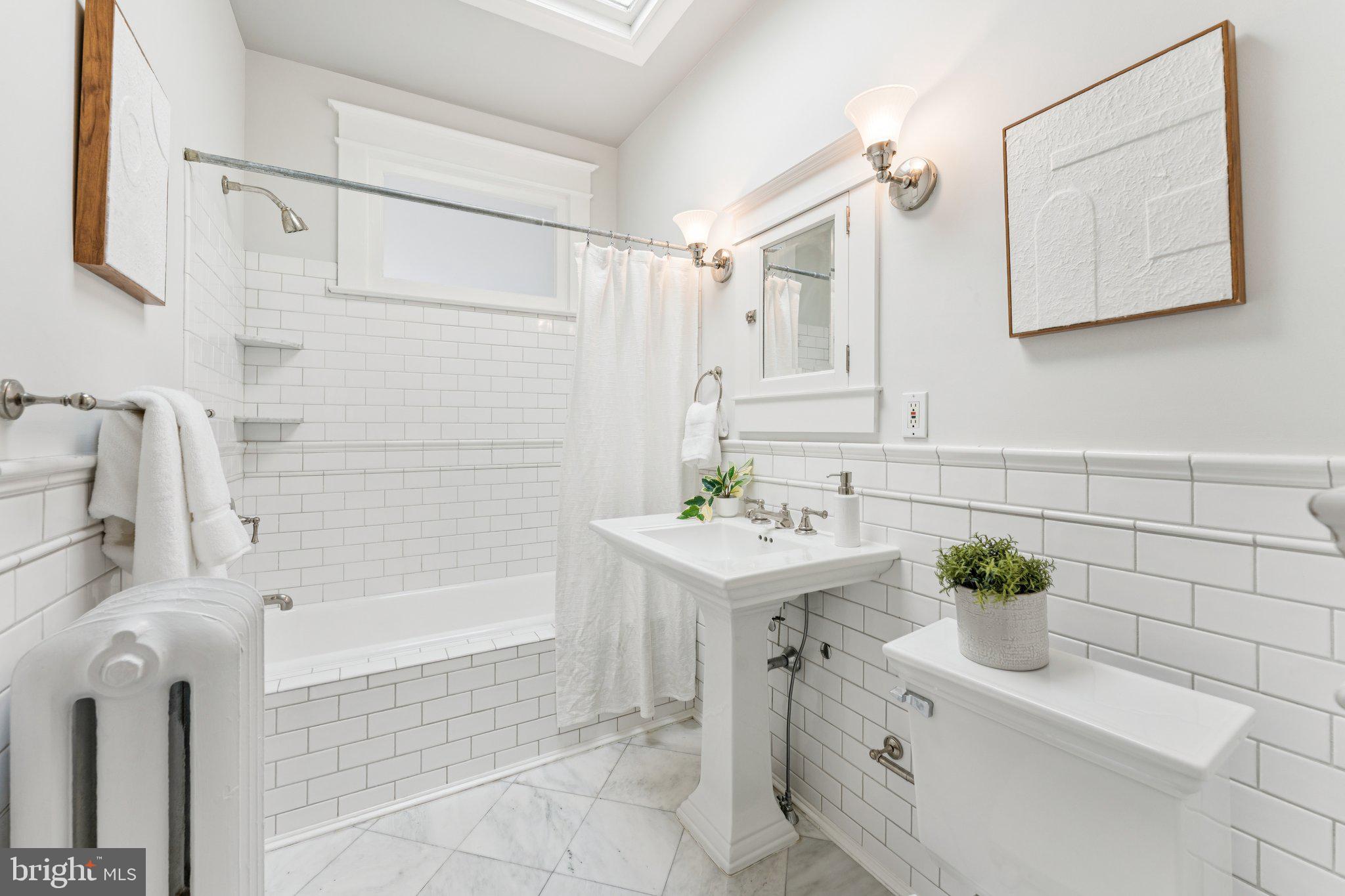 1412 Decatur Street Northwest Washington, DC 20011 - Photo 22 of 36 a bathroom with a sink a bathtub and a shower