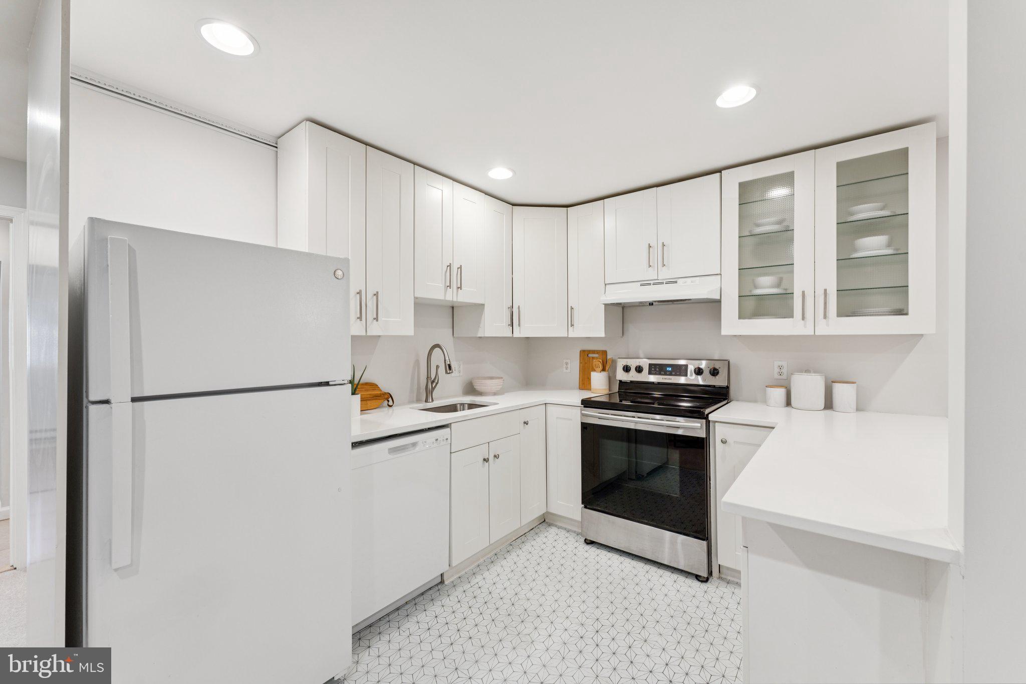 1412 Decatur Street Northwest Washington, DC 20011 - Photo 27 of 36 a kitchen with stainless steel appliances a refrigerator sink and cabinets