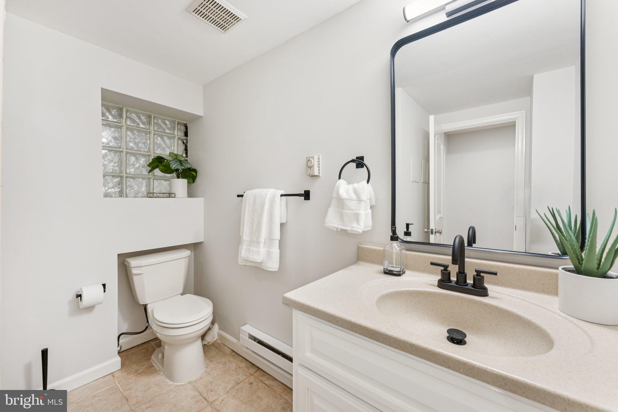1412 Decatur Street Northwest Washington, DC 20011 - Photo 32 of 36 a bathroom with a sink a toilet and a mirror