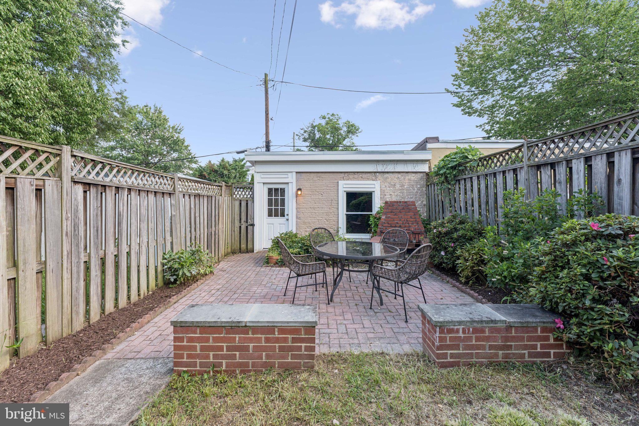 1412 Decatur Street Northwest Washington, DC 20011 - Photo 35 of 36 a view of a patio with table and chairs potted plants and wooden fence