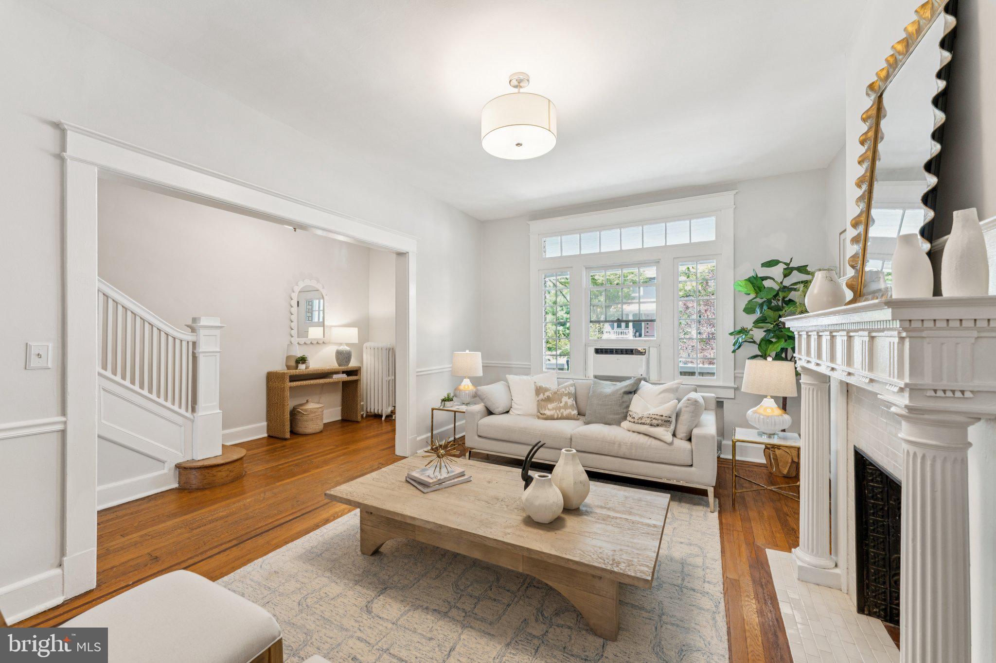 1412 Decatur Street Northwest Washington, DC 20011 - Photo 5 of 36 a living room with furniture a fireplace and a large window