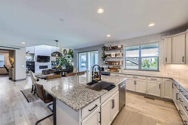 a kitchen with stainless steel appliances granite countertop a sink stove and cabinets