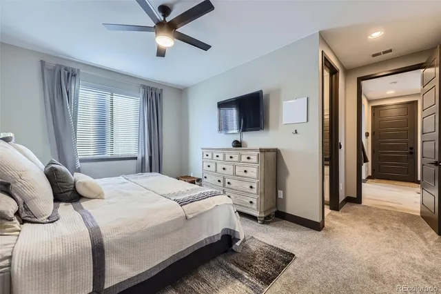 a bedroom with a bed and a television