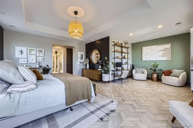 a bedroom with bed and a chandelier