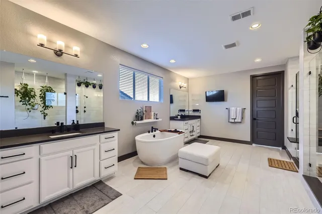 a living room with furniture a large window and white doors
