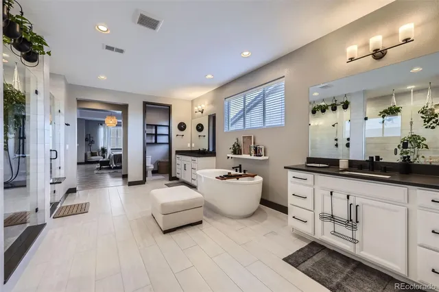 a large room with mirror and view of living room
