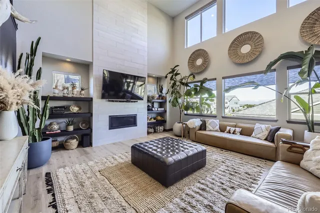 a living room with fireplace furniture and a flat screen tv