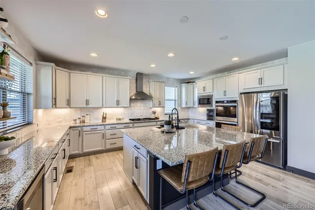 a kitchen with refrigerator stove microwave and cabinets