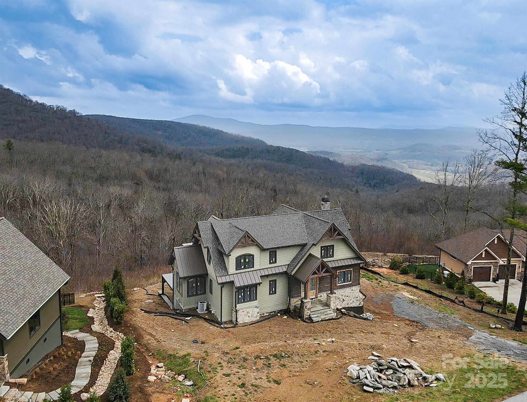 475 Dancing Bear Drive Hendersonville, NC 28792 - Photo 26 of 29 a view of a big house with a big yard and large trees