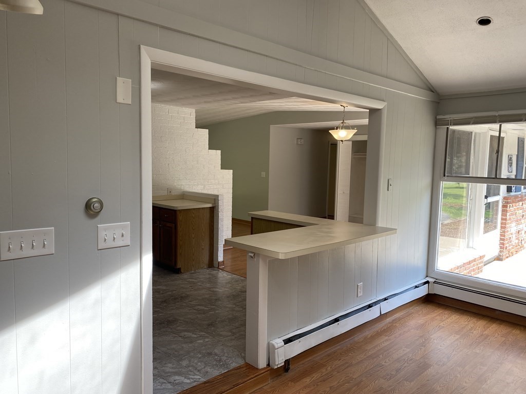 28 Savoy Road Framingham, MA 01701 - Photo 12 of 42 a view of a kitchen with a sink dishwasher and a fireplace