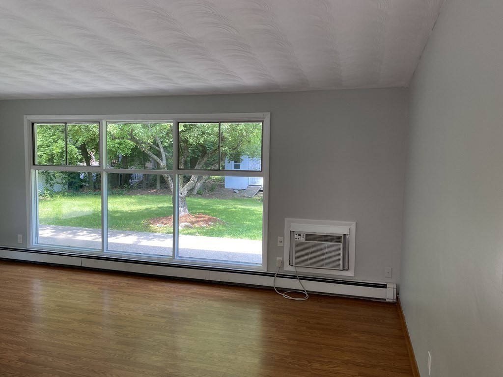 28 Savoy Road Framingham, MA 01701 - Photo 16 of 42 a view of an empty room with wooden floor and a window