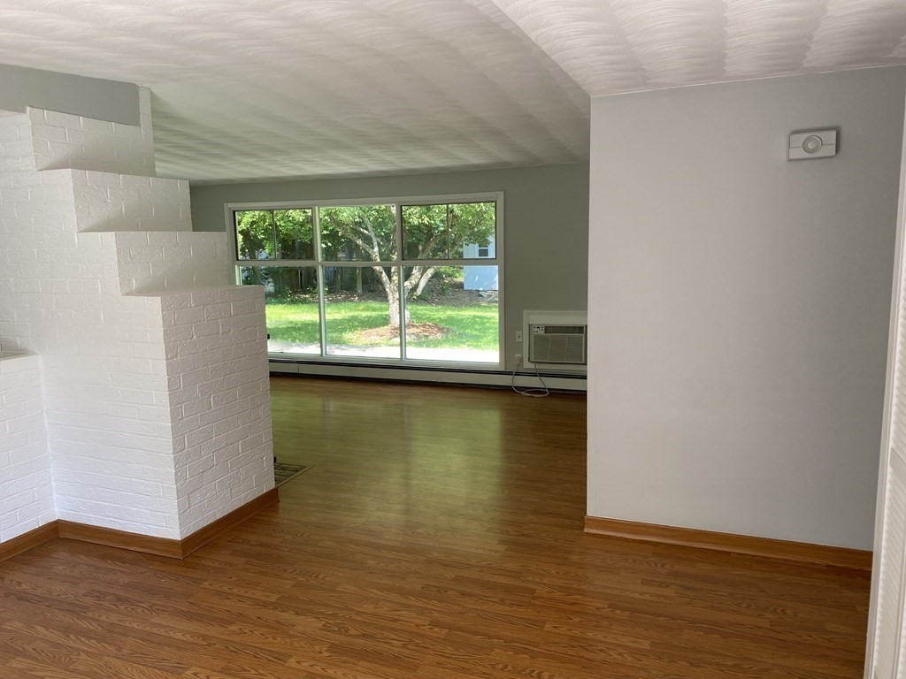 28 Savoy Road Framingham, MA 01701 - Photo 5 of 42 a view of an empty room with wooden floor and a window