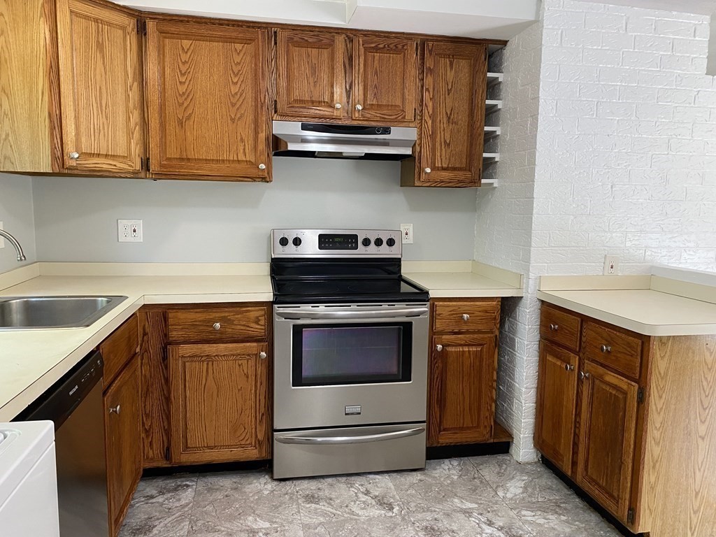 28 Savoy Road Framingham, MA 01701 - Photo 8 of 42 a kitchen with stainless steel appliances granite countertop a sink stove and microwave