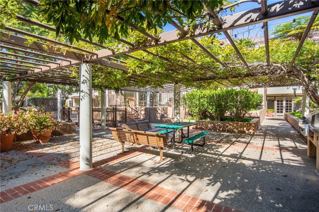 2571 Plaza Del Amo, Unit 107 Torrance, CA 90503 - Photo 32 of 33 a view of a patio with table and chairs and potted plants
