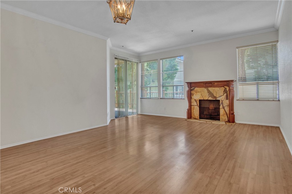2571 Plaza Del Amo, Unit 107 Torrance, CA 90503 - Photo 5 of 33 a view of an empty room with a window and wooden floor