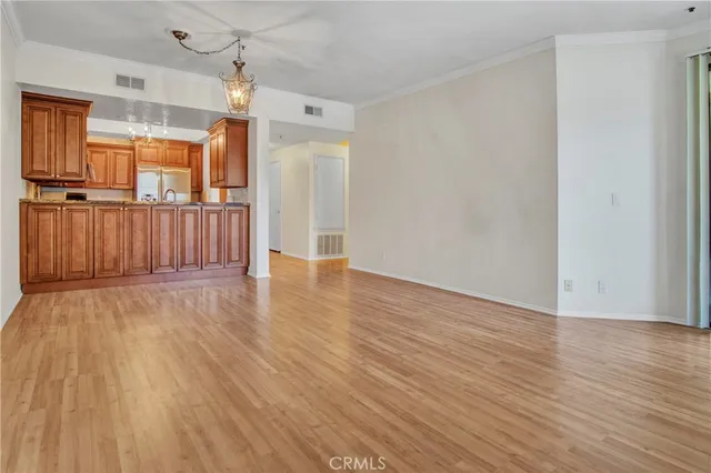 a view of a room with wooden floor and large window